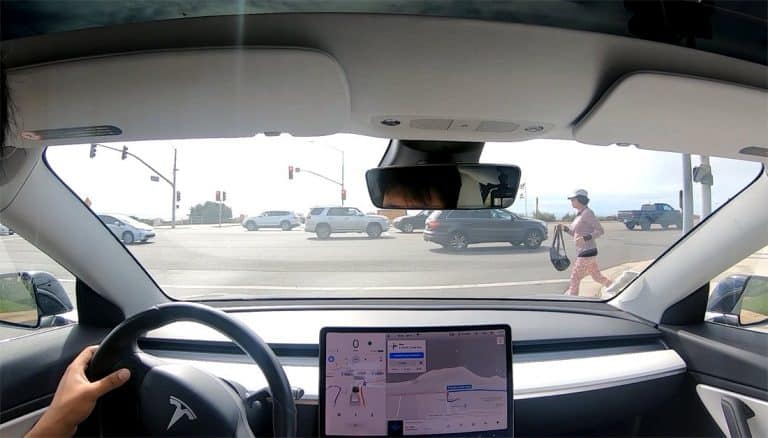 Tesla Full Self-Driving negotiates pedestrian traffic and safely turns right on red light