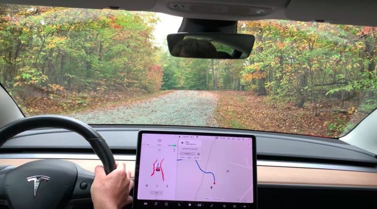 Tesla FSD beta navigates unpaved, partially covered road with ease