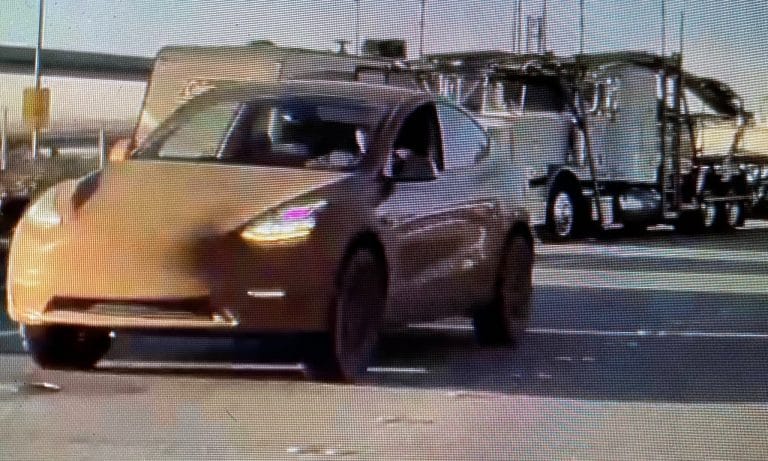 Tesla Model Y with large all-terrain tires and lift kit seen near Fremont Factory